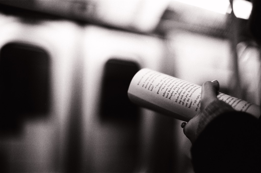 People on subway looking at phones