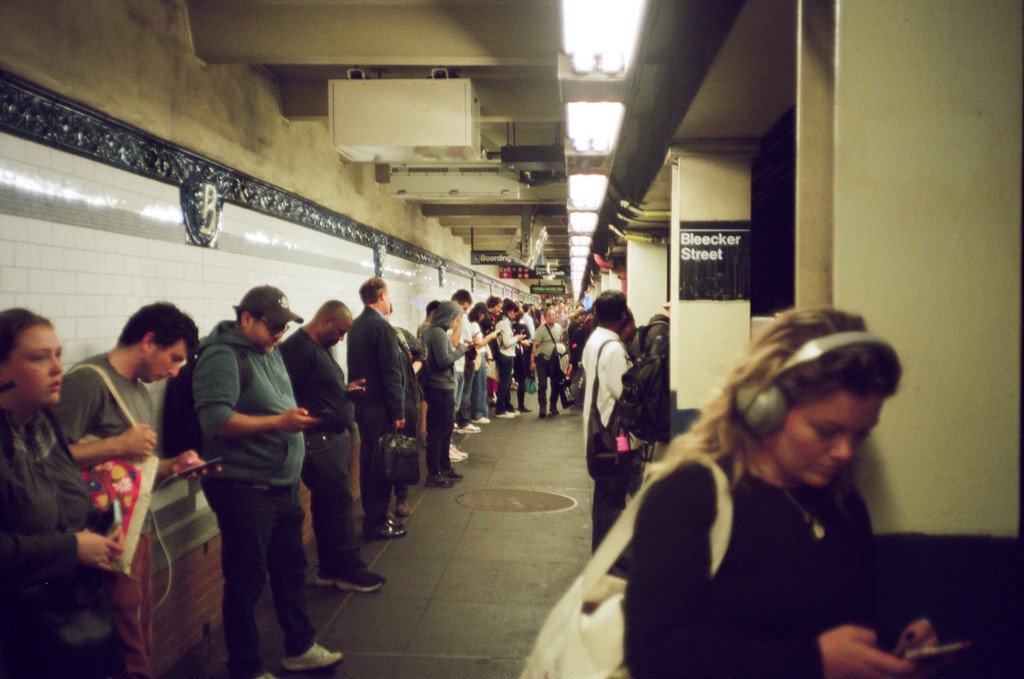 Concert-goers watching through phone screens